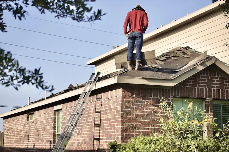 Professional roofer working on a residential roof in Creek Cove